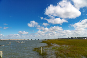 Long bridge across the bay at Chincoteague Island, a sanctuary with rare birds in the swamps. clouds and blue sky.