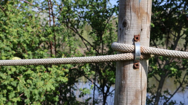 Fence rope stretched a wooden post on the right side