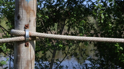 Fence tight rope a wooden post on the left side