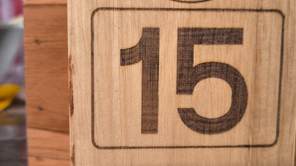 Number 15 on wooden background