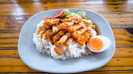 Crispy pork rice on a blue plate on the dining table