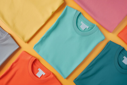 Vibrant display of neatly arranged t-shirts in various colors in a flat lay composition