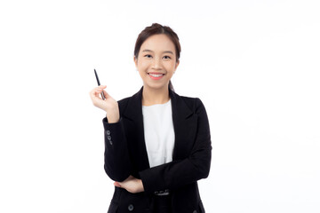 A cheerful young asian businesswoman in a suit, smiling and looking up, holding a pen, celebrating...