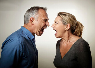 Middle aged couple shouting at each other isolated on white, studio shot, marriage problem concept, character control and human relationships.