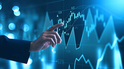 Investing and stock market concept. A businessman touching graph financial data charts for trading...