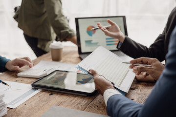 Businessman and businesswoman are in a working meeting with many financial documents on the table....