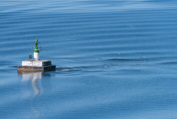 A small rock with and light house in the outer archipelago a sunny spring day in Stockholm