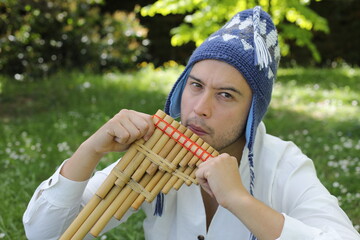 Native American man playing a wooden flute