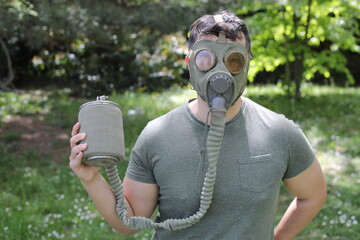 Man wearing vintage gas mask in natural setting