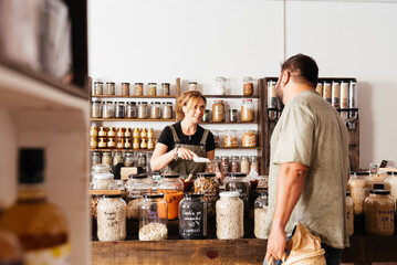 Man and Woman Shopping Food at Bulk Grocery Counter