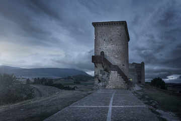 Dusk view of the ruins of the castle of Santa Gadea del Cid, Burgos under a dramatic cloud-covered...