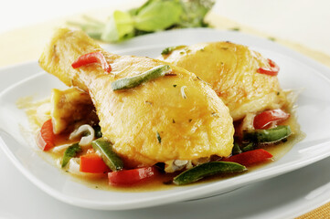 Two baked chicken drumsticks with assorted vegetables