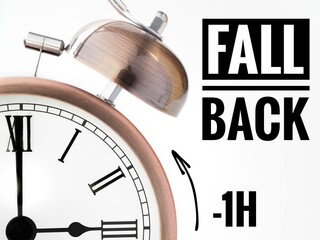  Fall back or time change concept. Alarm clock at 3 o'clock changing to Winter Time