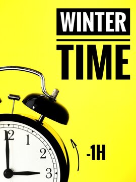 Alarm clock at 3 o'clock changing to Winter Time. Fall back or time change concept