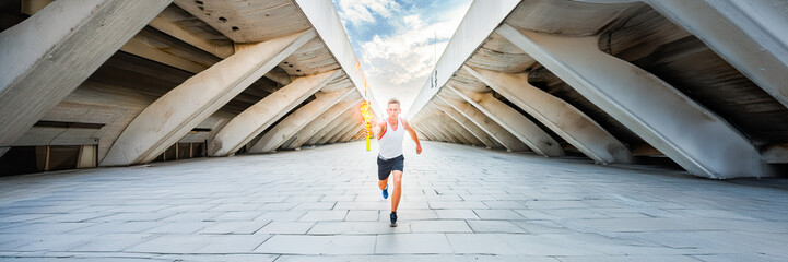 runner in corridor architecture holding the torch
