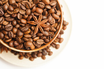 Cup with coffee beans and spices on white background. Top view