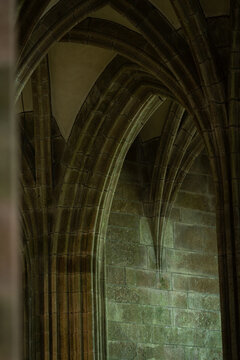 Vertical shot of the vaulted gothic arches inside a cathedral.  View of the rib vaults and the pillars.