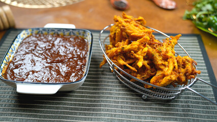 Potato Pakora, Palak Pakora with Tamarind Chutney and Potato Ketchup on the table