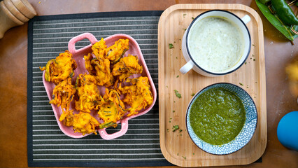 Potato Pakora, Palak Pakora with Green Chutney and Mint chutney on the table