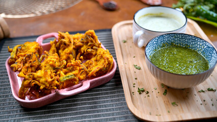 Potato Pakora, Palak Pakora with Green Chutney and Mint chutney on the table