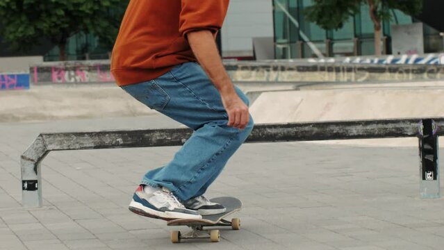 Young skater making 360 flip jump, performing kickflip trick, skateboarder training in skatepark, making tricks, slides and flips, professional extreme sport athlete training ride on skateboard. 