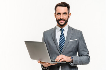 Successful young businessman working on laptop isolated over white background. Confident manager...