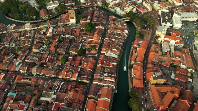 Drone shot of Malacca City in Malaysia, with a passing boat adding to the scene.
