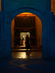 Muslim woman waiting in front of a mosque