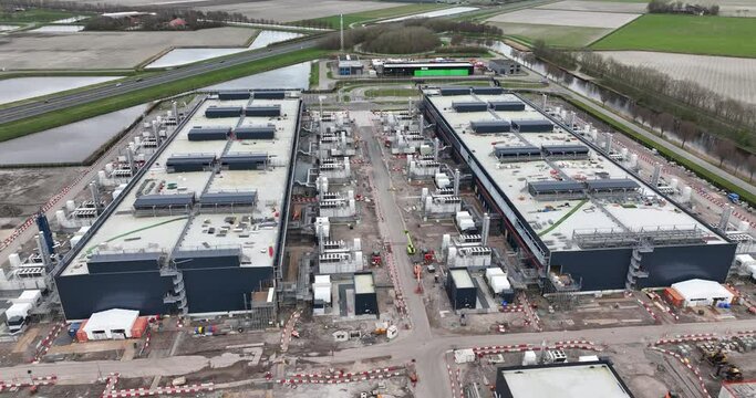 Internet infestructure. Exterioir aerial view on data centers in the dutch Polder, controversial because of massive electricity usage. Aerial drone view on Big tech companies and cloud infrastructure.