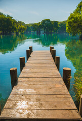 Dock on Lake Camecuaro Michoacán, Mexico, with its amazing turquoise waters, where the roots of...