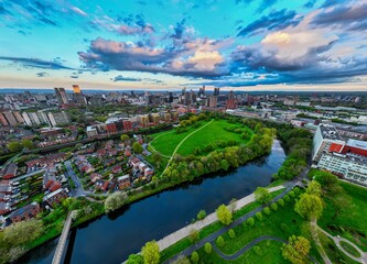 Ultra wide aerial shot of Manchester and Salford over the Peel park and the Meadow, showing River Irwell 