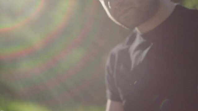 Young man reading his Bible outside on a warm sunny day