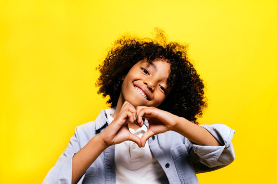 Black kid in studio smiling.