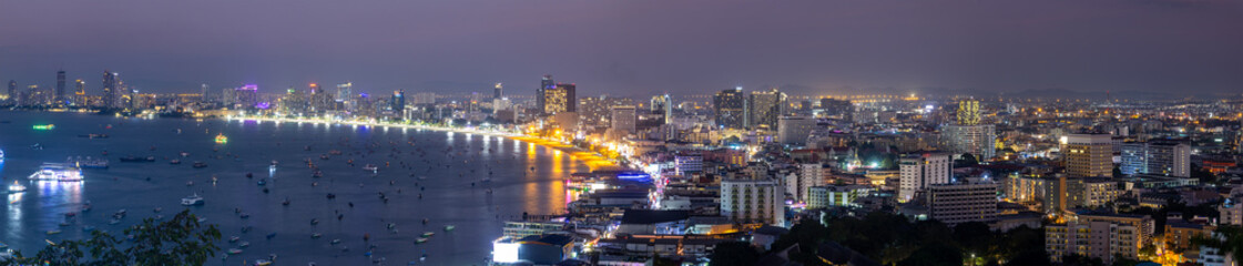 Panoramic view of Pattaya cityscape and Sea during twilight, the eighth-largest city in Thailand. - obrazy, fototapety, plakaty