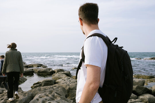 Coastal Walk Along Rocky Shoreline by three friends