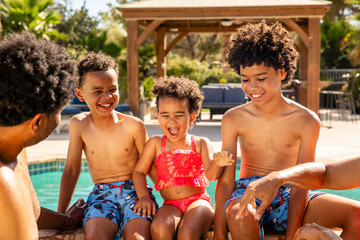 Happy Family Plays Together While At The Pool On Vacation
