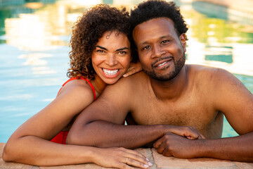 Middle-Aged Couple Smiles At Camera While In The Pool 