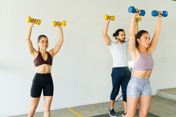 Group of people exercising with dumbbells in a fitness class