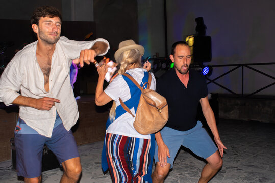 Funny and goofy people dancing together