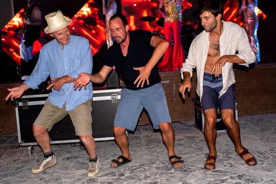 Trio of synchronised dancers under the stage
