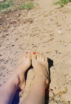 Bare Feet With Red Nail Polish on a Sandy Trail