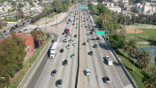 Trucks and cars in Los Angeles commute on a busy highway freeway traffic