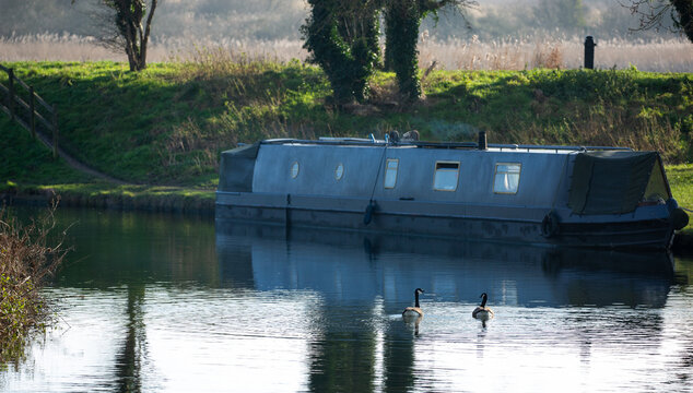 Narrowboat on a canal on a winter's morning.