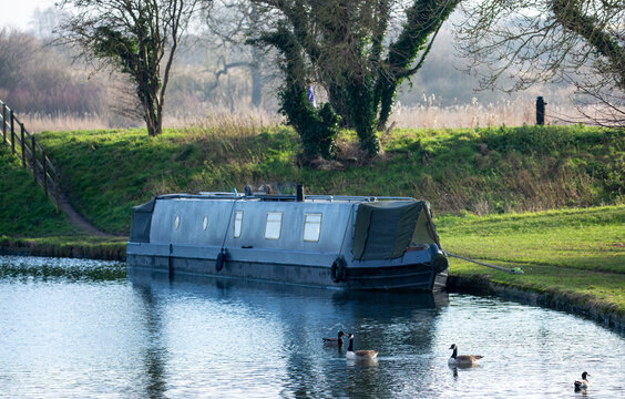 Narrowboat on a canal on a winter's morning.