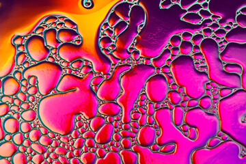 Abstract liquid background in bright colors pink, purple and yellow