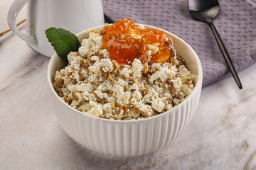 Curd with granola and orange jam