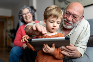 Grandparents playing with their grandson