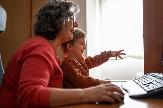 Adorable little boy enjoying with his grandmother