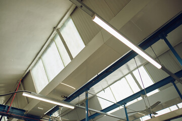 A rustic old factory skylight window in an industrial manufacturing factory setting. Retro and...