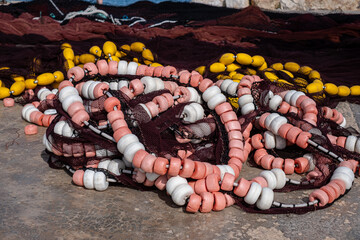 The seaside clutter of vibrant buoys and nets, a common yet captivating sight along the docks,...